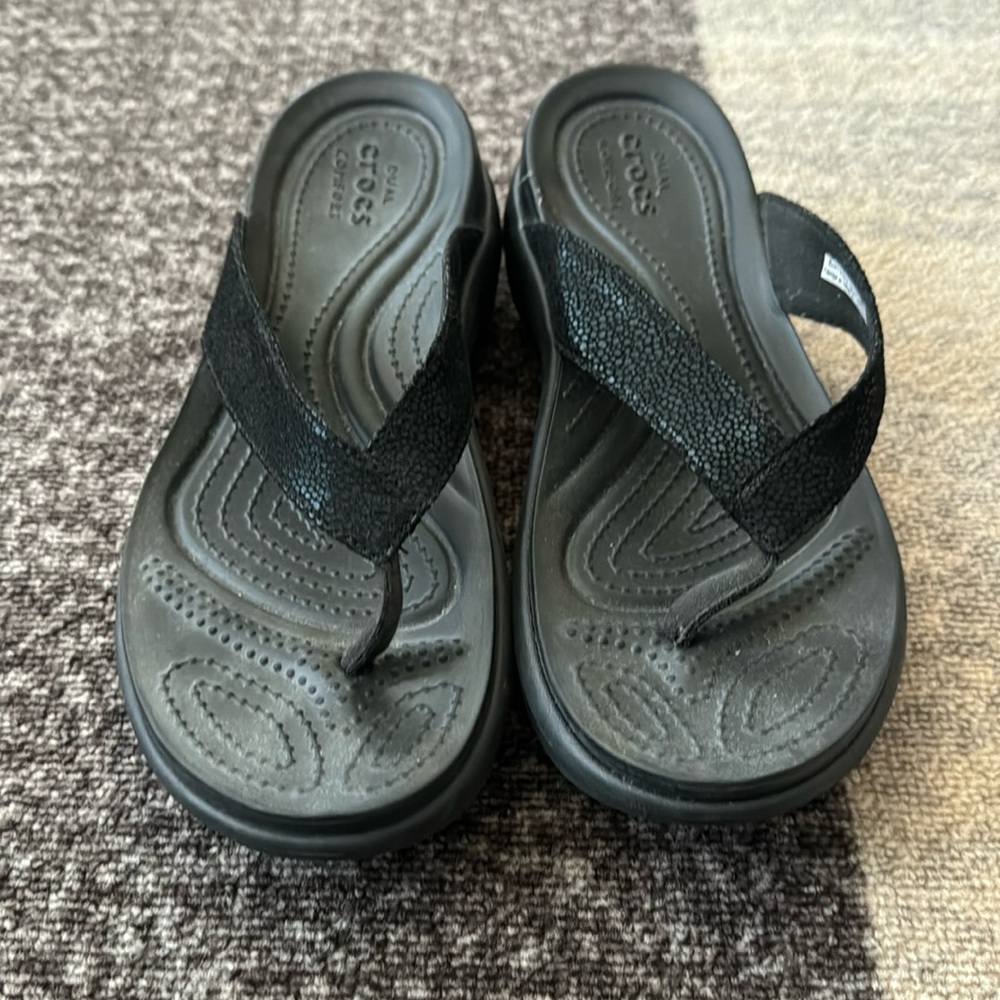 Black pair of croc flip flops women’s size 8